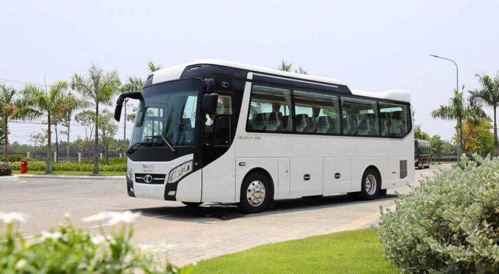 a white bus on a road